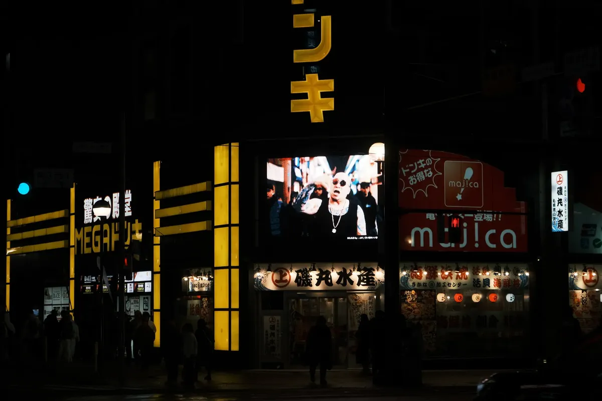 Neon-lit street scene at night in Sapporo, Japan, showcasing the vibrant city nightlife.
